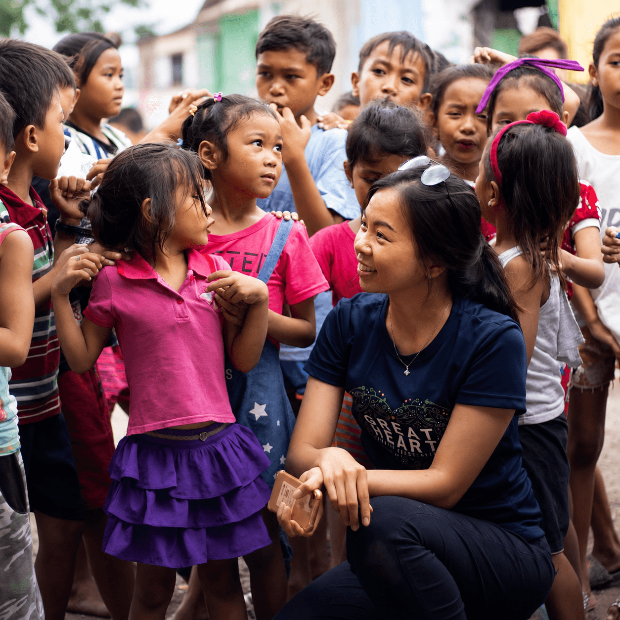 A Great Heart volunteer spending time with children in the community