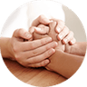 Hands gently holding another person’s hand