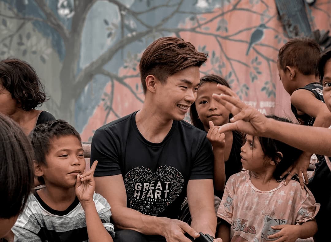 Ric See spending time with children during a community visit