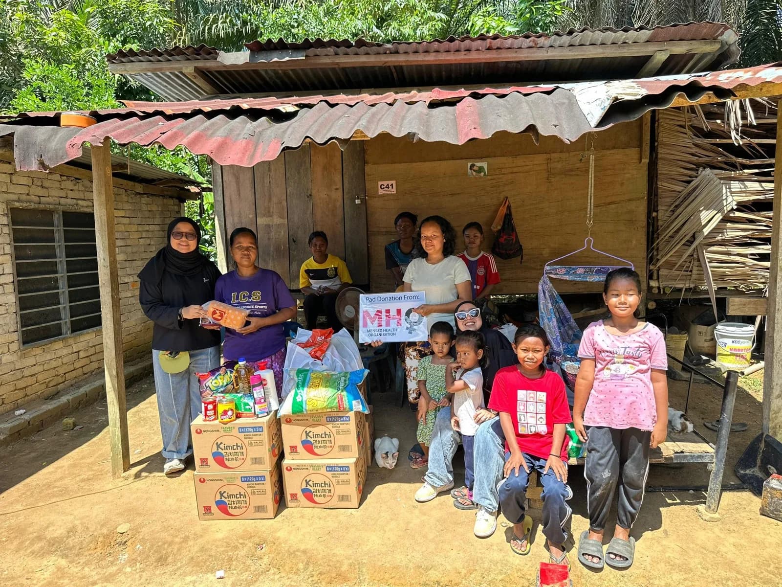 A Great Heart volunteer surrounded by children
