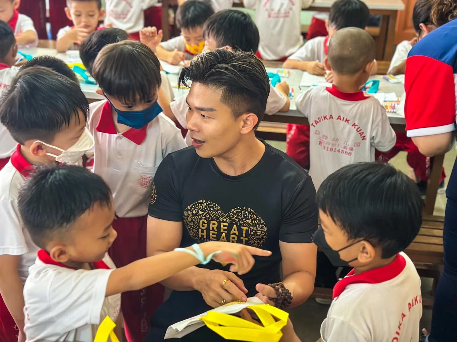 A Great Heart volunteer spending time with children