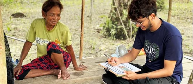 A volunteer speaking with a community member during an outreach visit
