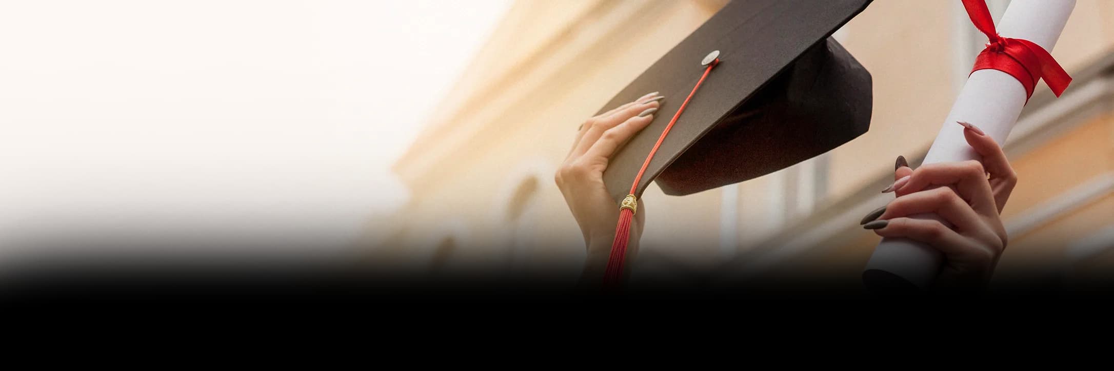 Graduate holding a mortarboard and diploma