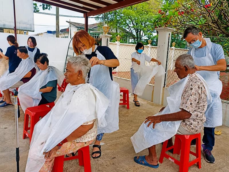 Volunteers providing free haircuts for elderly beneficiaries
