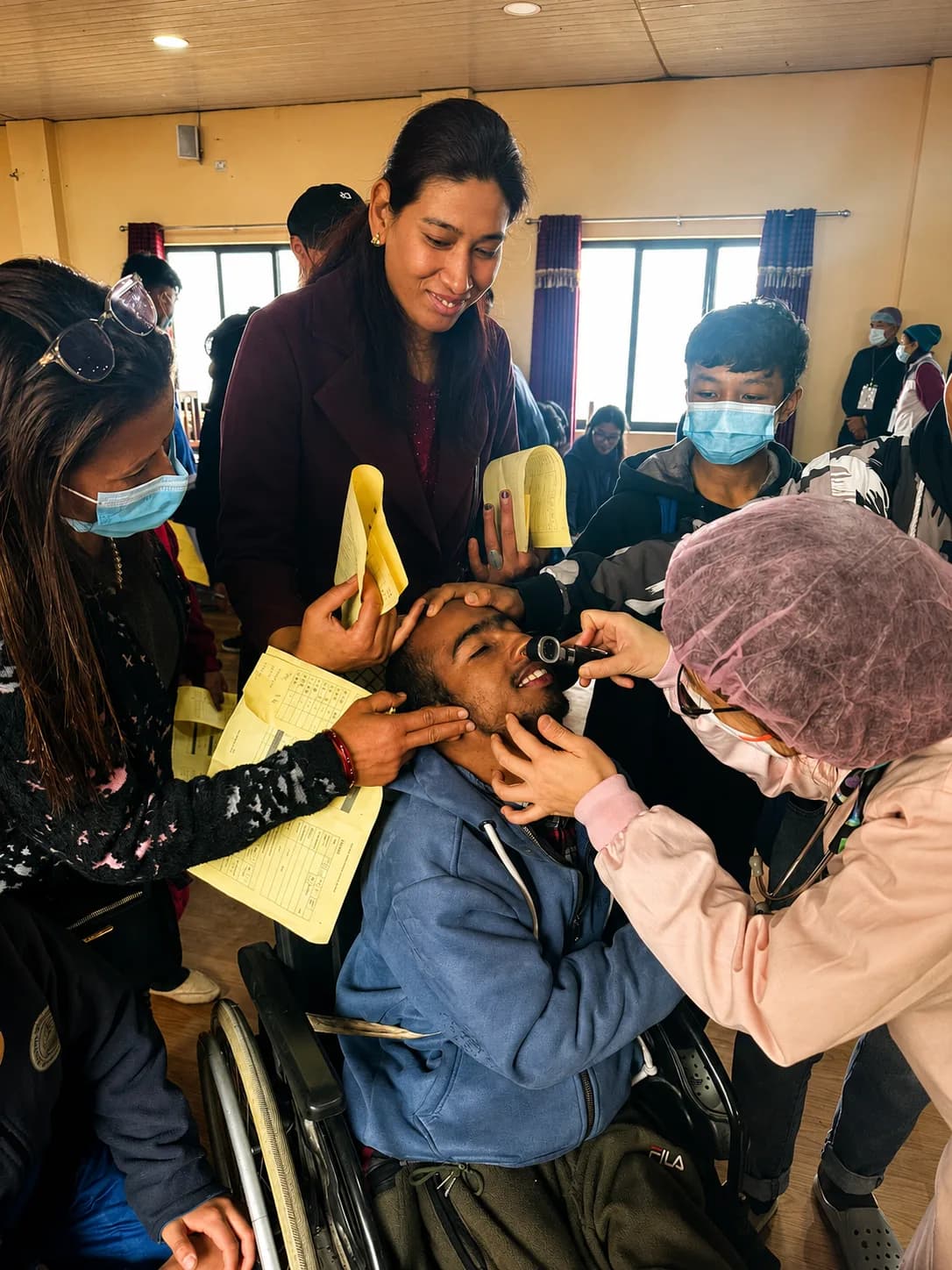A medical volunteer providing a health check during an overseas outreach programme