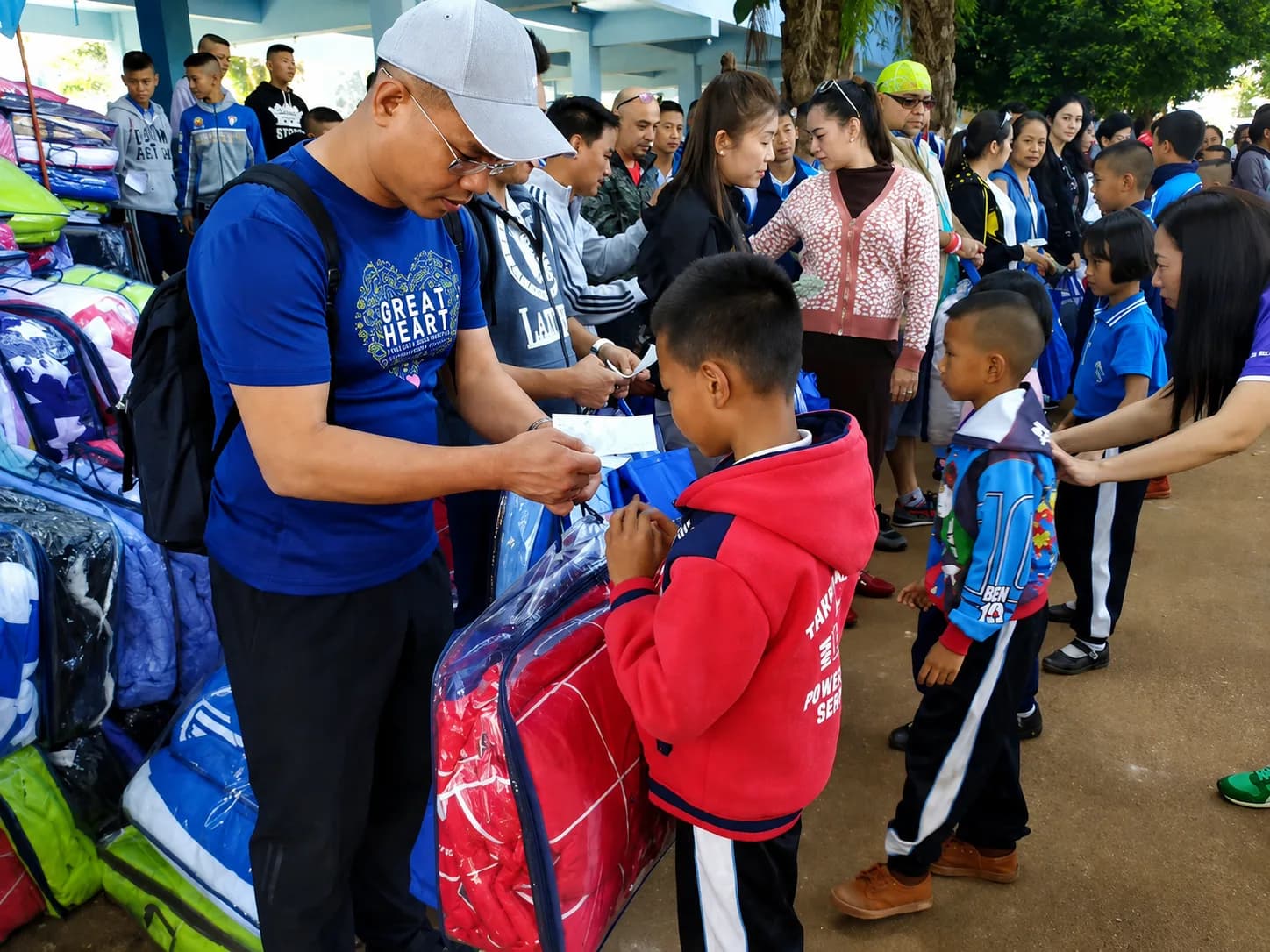 Great Heart volunteers distributing school supplies to children