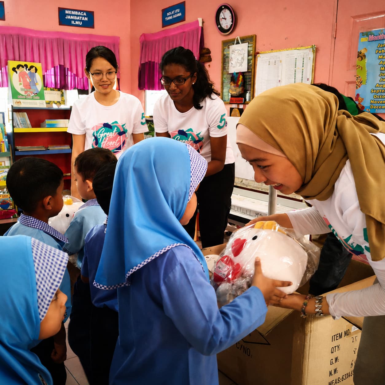Student volunteers sharing gifts with children during a Great Heart school outreach activity