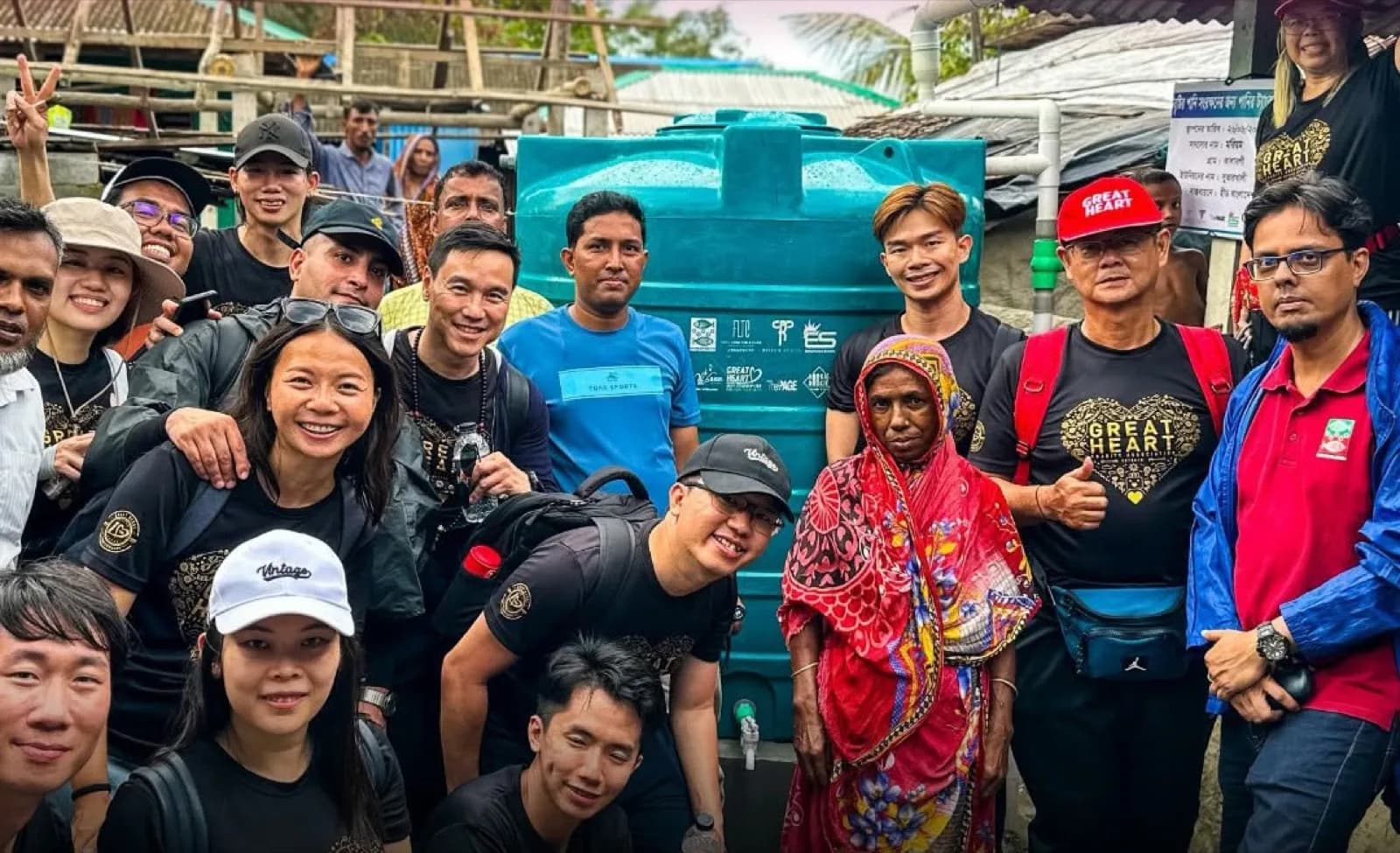 Great Heart volunteers with a community receiving clean water support