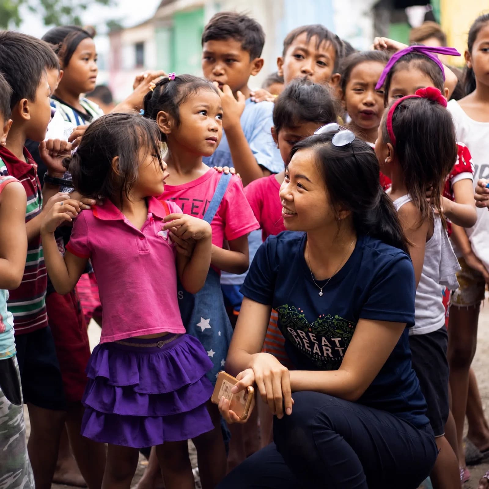 A Great Heart volunteer spending time with children