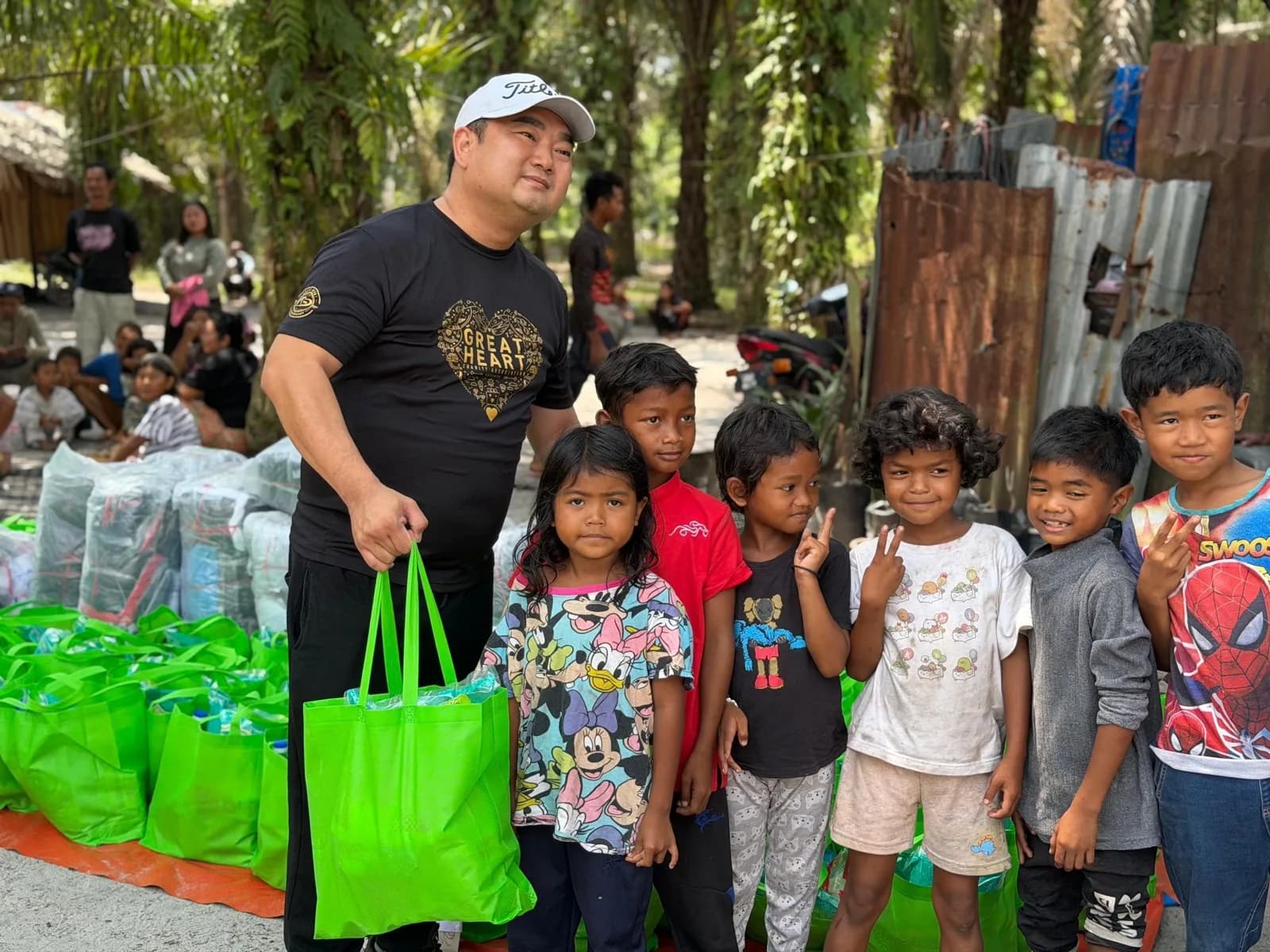 A volunteer distributing care bags to children