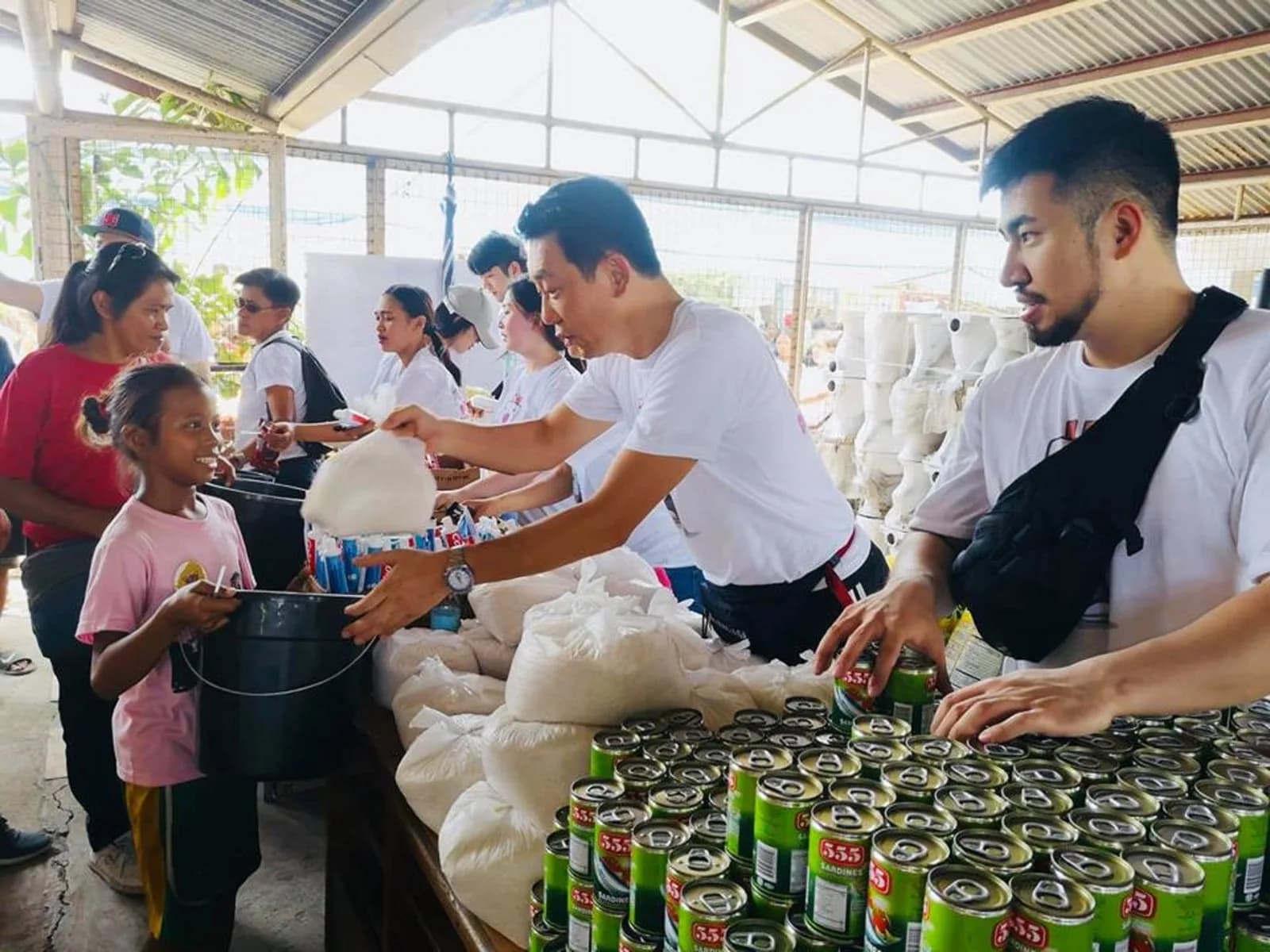 Volunteers distributing food supplies to families