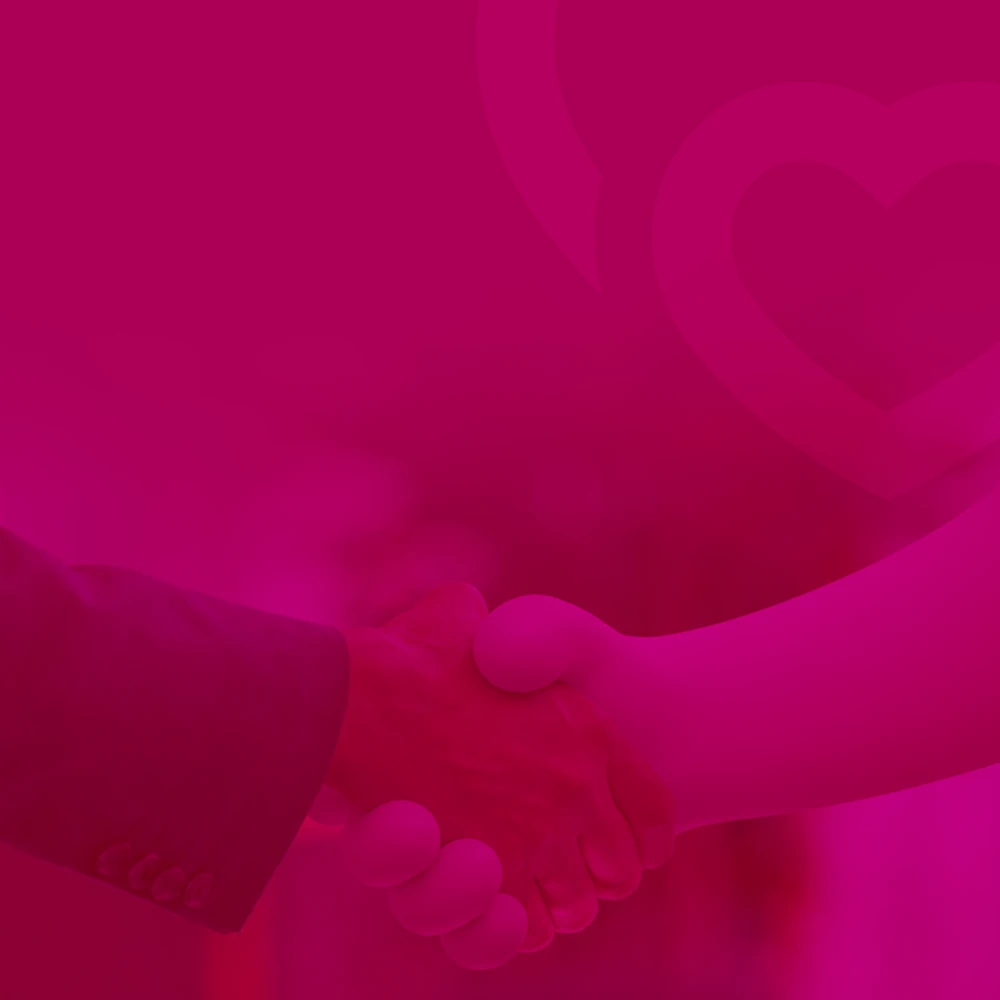 A handshake beneath a heart motif